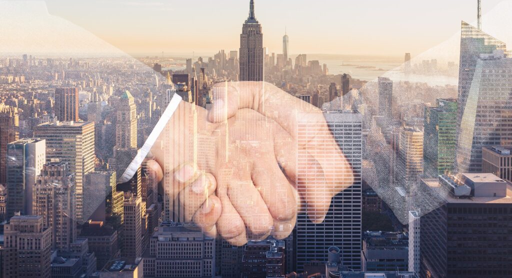 transparent image of a handshake over the backdrop of a city